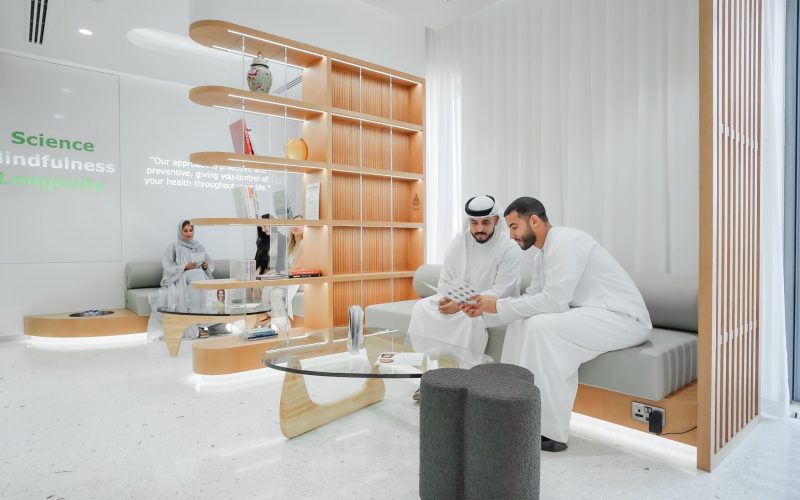 DNA Health Abu Dhabi Reception Clients reading Food intolerance test (FIT) report.